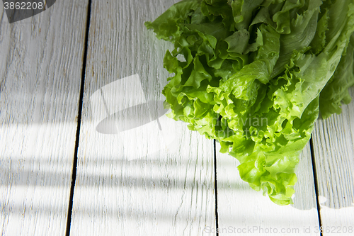 Image of lettuce salad on a wood