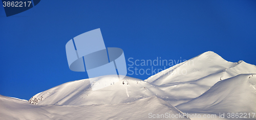 Image of Panoramic view on off-piste slope and blue clear sky in morning