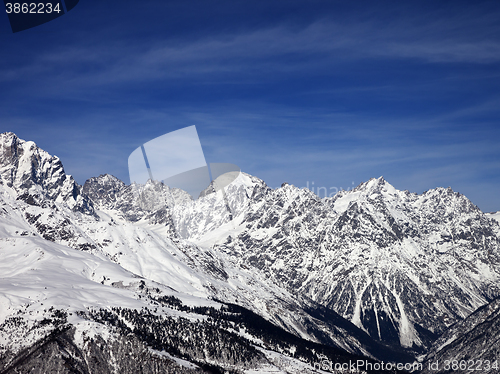 Image of Snowy mountains in wind sunny day