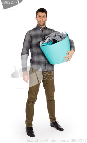 Image of Full length portrait of a young man holding a laundry basket