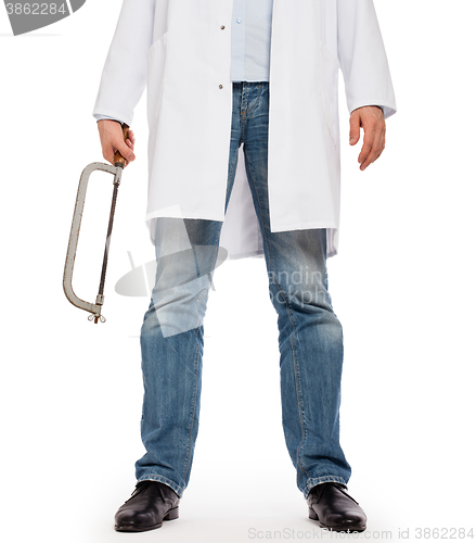 Image of Crazy doctor is holding a big saw in his hands