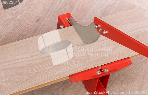 Image of Red tool for cutting laminate