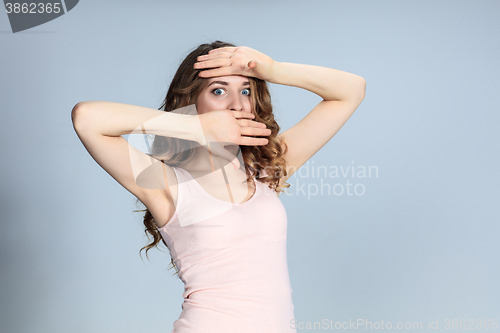 Image of Portrait of young woman with shocked facial expression