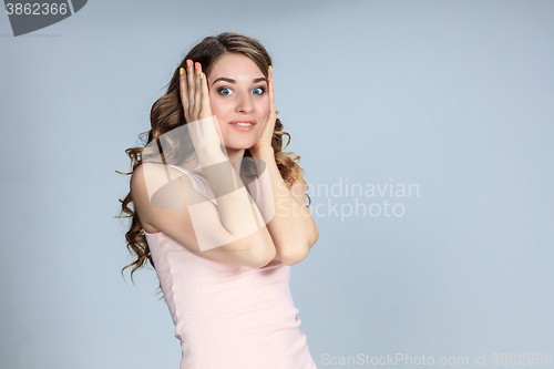 Image of Portrait of young woman with shocked facial expression