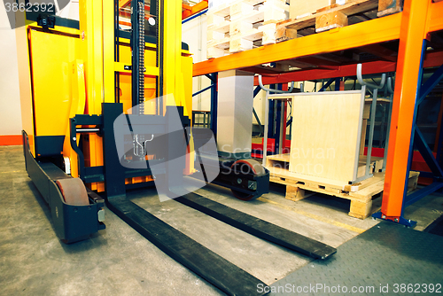 Image of Shelves, racks and forklift  with pallets in distribution wareho