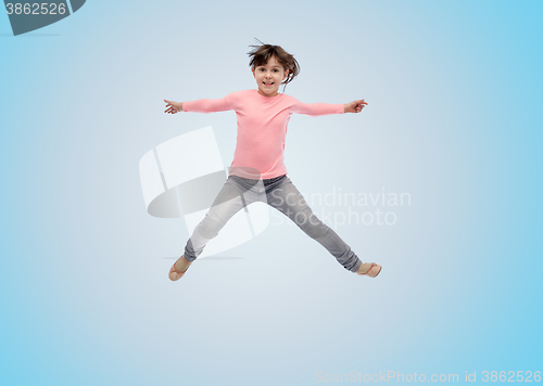 Image of happy little girl jumping in air