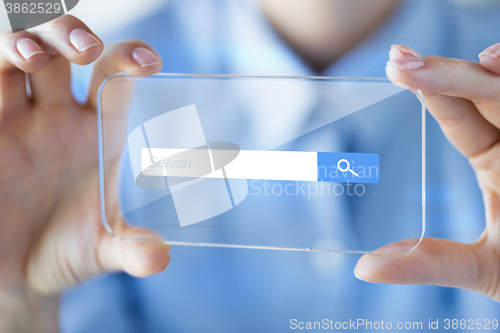 Image of close up of woman with transparent smartphone