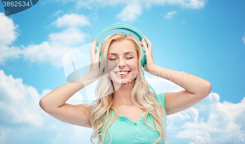 Image of happy young woman or teenage girl with headphones