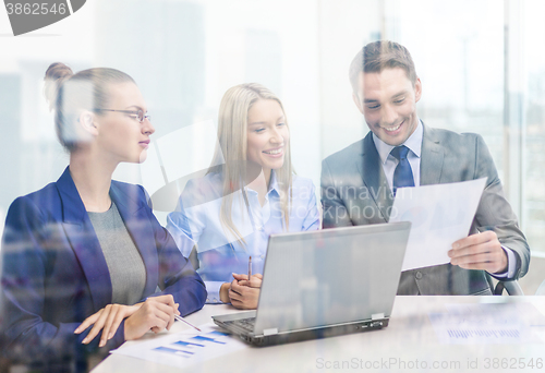 Image of business team with laptop having discussion