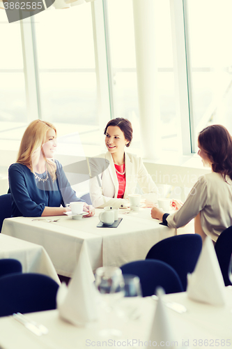 Image of women drinking coffee and talking at restaurant