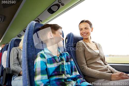 Image of happy family riding in travel bus