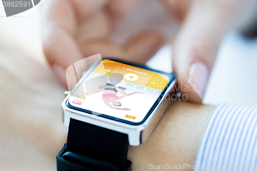 Image of close up of hands setting sport app on smartwatch