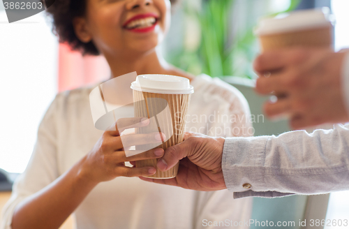 Image of close up of happy woman hand taking coffee cup