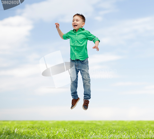 Image of happy little boy jumping in air