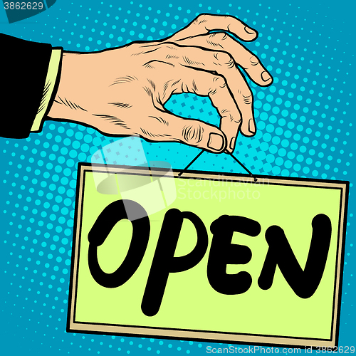 Image of Hand holding a sign open