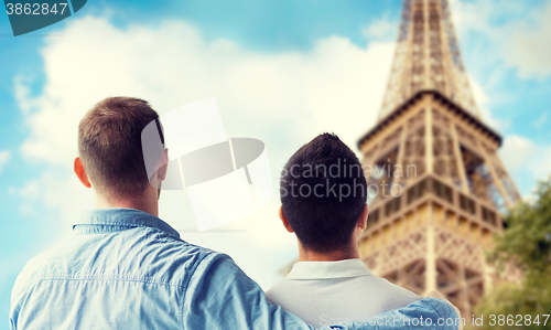 Image of close up of male gay couple over eiffel tower