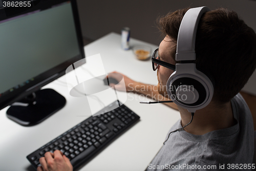 Image of close up of man playing computer video game