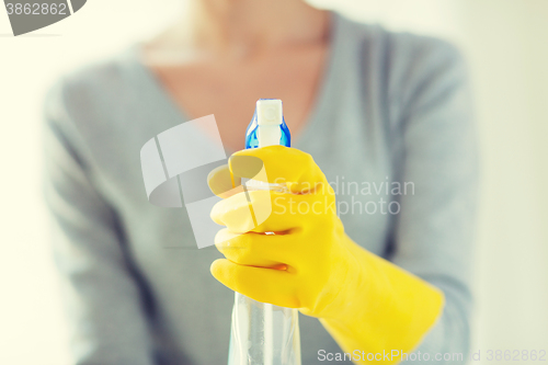 Image of close up of happy woman with cleanser spraying