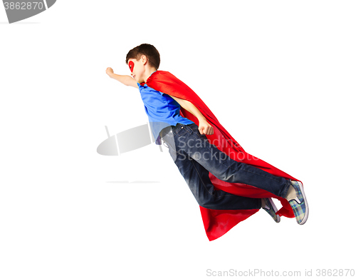 Image of boy in red superhero cape and mask flying on air