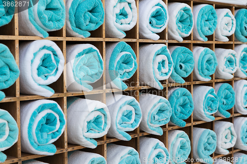 Image of close up of shelf with rolled bath towels