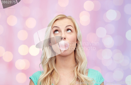 Image of happy young woman or teenage girl chewing gum