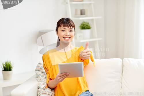Image of happy asian woman with tablet pc and thumbs up