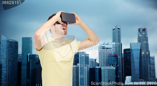 Image of happy man in virtual reality headset or 3d glasses