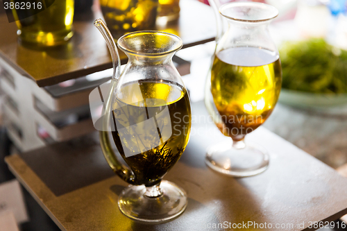 Image of close up of glass jug with extra vergin olive oil