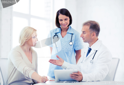 Image of doctor and nurse with patient in hospital