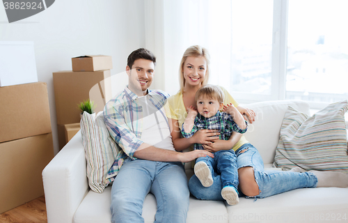 Image of happy family with boxes moving to new home