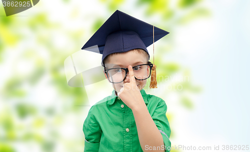 Image of happy boy in bachelor hat and eyeglasses