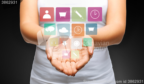 Image of close up of womans hands with app menu icons