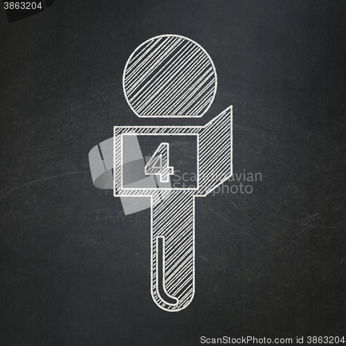 Image of News concept: Microphone on chalkboard background