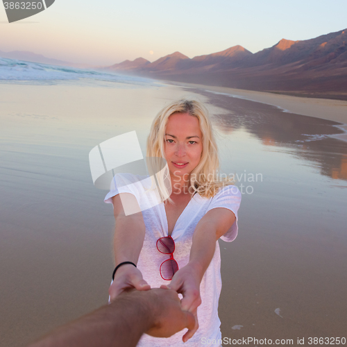 Image of Romantic couple having fun on beach.