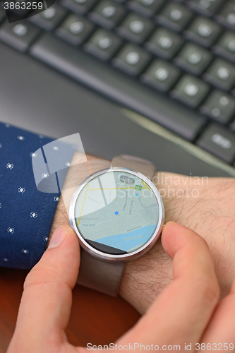 Image of Hands with map on smartwatch 