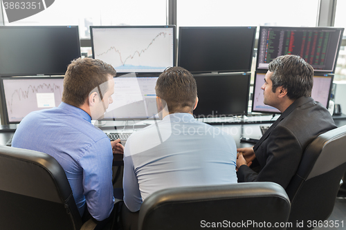 Image of Business people looking at computer screens.