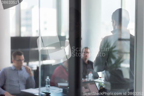 Image of Business team leader delivering presentation in office.