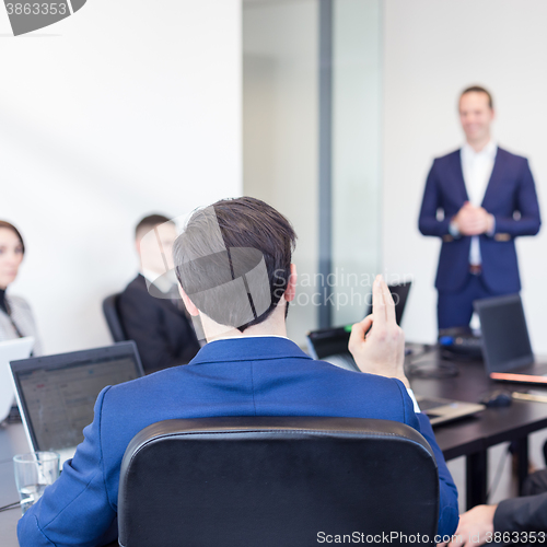 Image of Colleague asking question to business team leader.