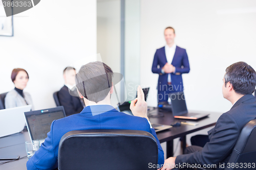 Image of Colleague asking question to business team leader.