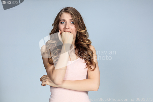 Image of Portrait of young woman with shocked facial expression