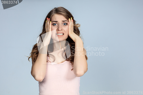 Image of Portrait of young woman with shocked facial expression