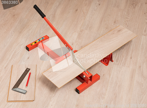 Image of Red tool for cutting laminate