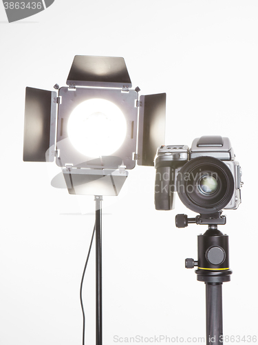 Image of medium format  proffesional camera and studio light with barn doors