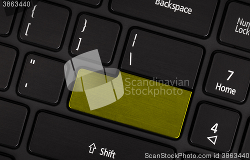 Image of Laptop computer keyboard with blank yerllow button