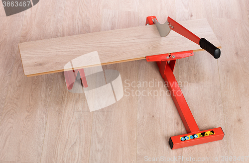 Image of Red tool for cutting laminate