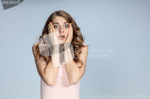 Image of Portrait of young woman with shocked facial expression