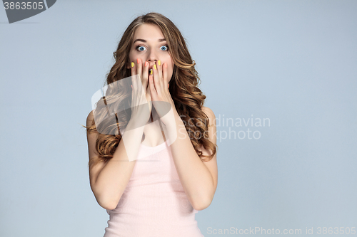 Image of Portrait of young woman with shocked facial expression