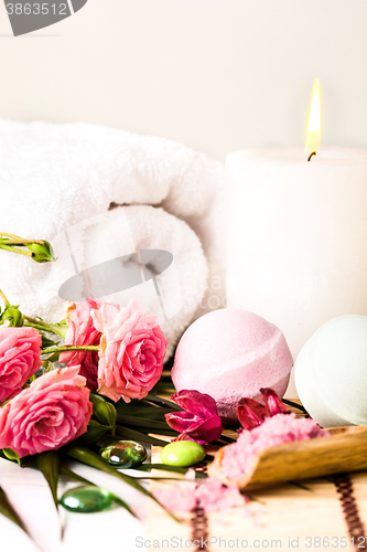 Image of Spa setting with pink roses and aroma oil, vintage style 