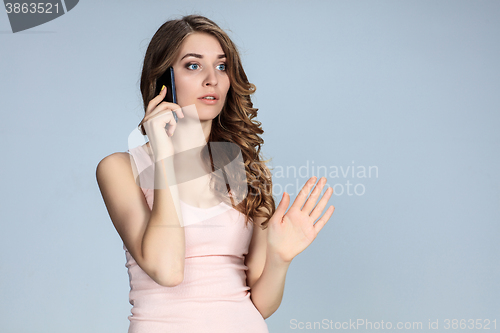 Image of Portrait of young woman with phone