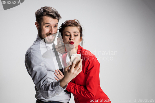 Image of Two colleagues friends taking selfie with telephone camera 